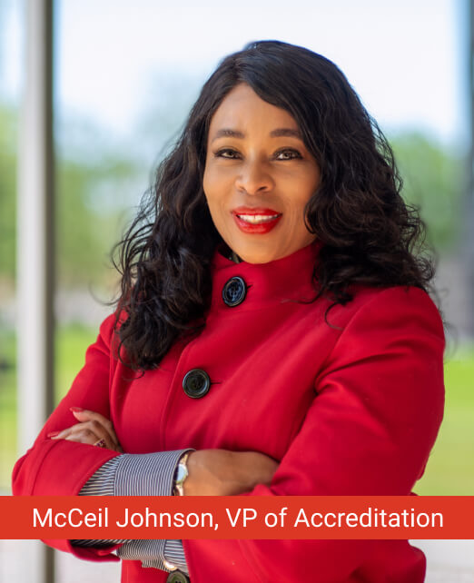 Headshot of McCeil Johnson, VP of Accreditation at University of Phoenix, smiling confidently in a bright red jacket.