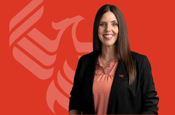 A picture of Kathryn Uhles with the University of Phoenix logo behind her