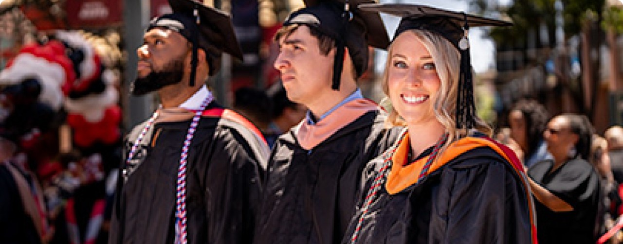 Three proud University of Phoenix graduates
