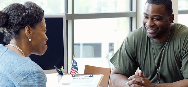 Two individuals discussing support for military students