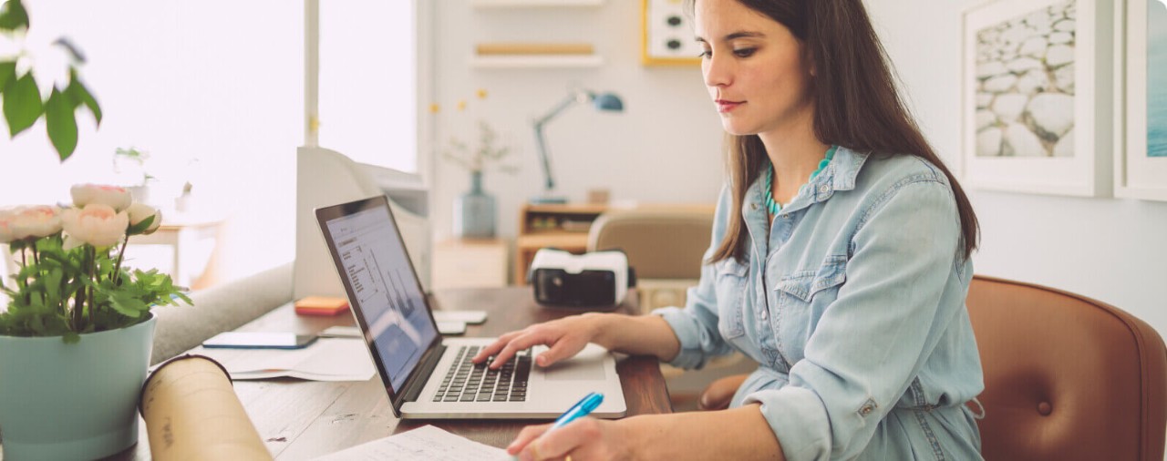 Expecting woman working on a laptop