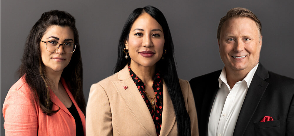 Three university deans in business attire stand side by side, exuding confidence and unity