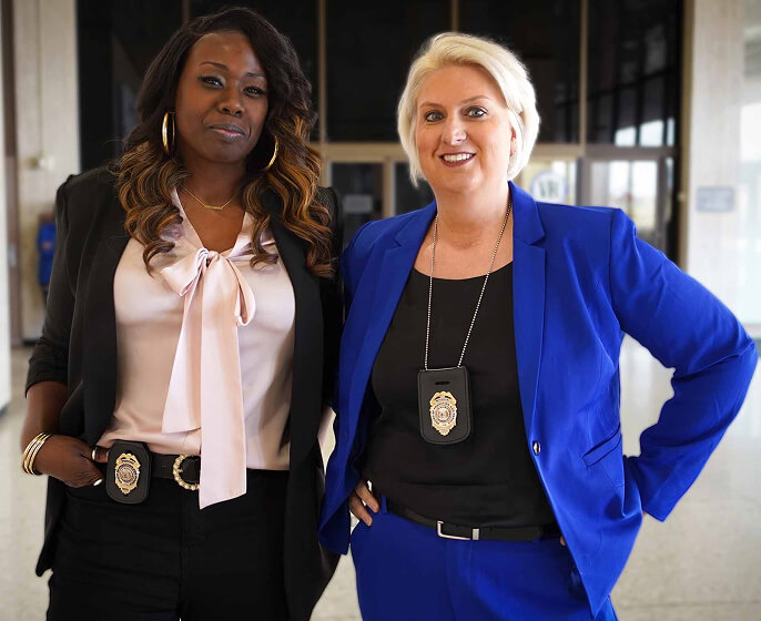 Two correction officers stand together