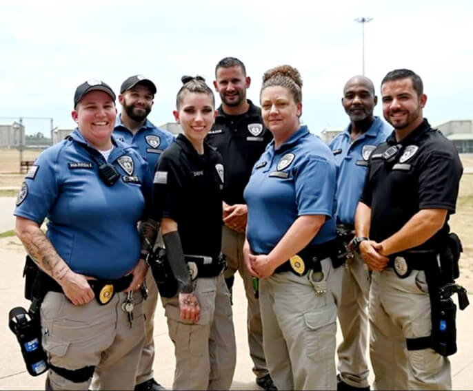 A group of correction officers stand together.