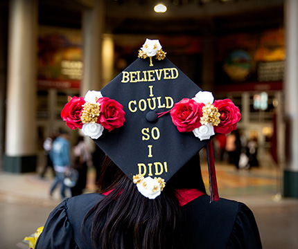 Graduate with cap that has "I believed I could so I did" written on it
