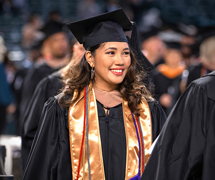 Graduate walking in line to receive diploma