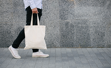 Person walking with a bag of shopping goods