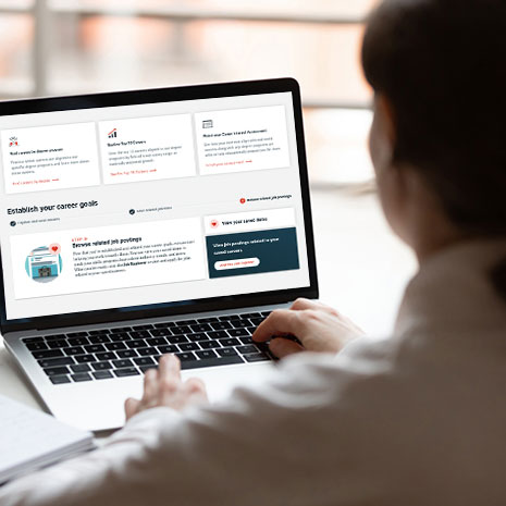 man using laptop to review his career goals
