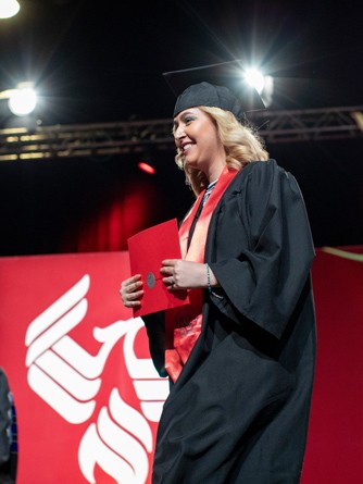 Darrielle accepts her diploma at graduation 