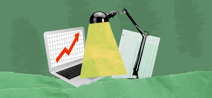 Lamp illuminating a laptop displaying a graph to signify careers in finance and accounting
