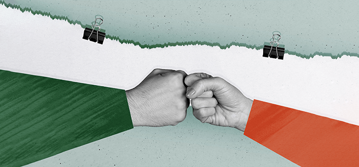 Two hands doing a fist bump, one wearing a green sleeve and the other a red sleeve to signify the difference between business analytics and intelligence