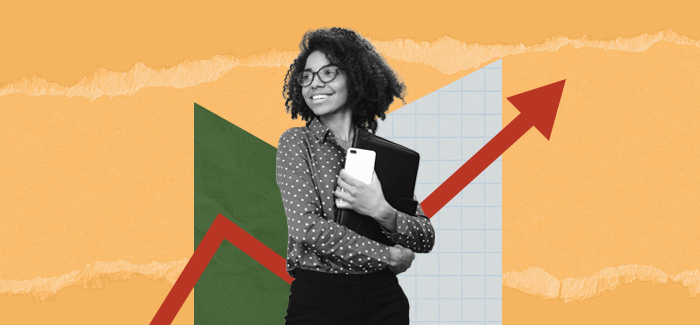 A woman holding a calculator in front of a chart to signify a business management degree.