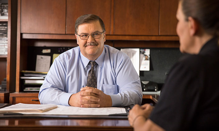 Two men discuss a correctional program for community-based corrections