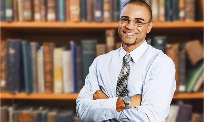 School principal smiling with his arms crossed to signify one of the many careers in education