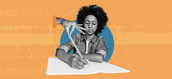 A teacher's hand reaching out to touch a student's pencil while they write to signify curriculum and instruction