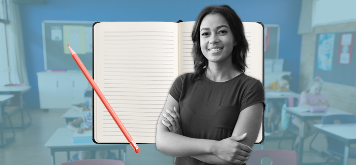 Female teacher in a classroom, with a notebook and pencil in the background where she will write her teaching philosophy statement