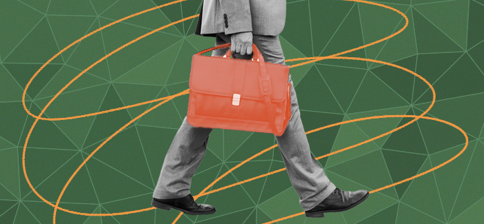 a veteran-owned businessman walking and holding a briefcase