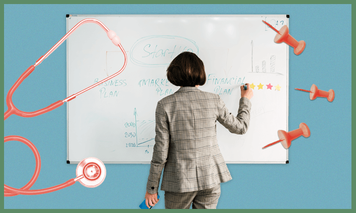 A female health services manager business woman writing on a white board