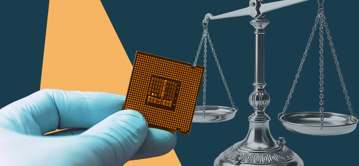 The gloved hand of a computer forensics expert holding a microchip in front of the scales of justice