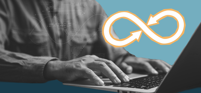 Hands typing on a laptop to represent what is devops