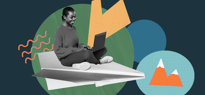 A woman sitting on a paper airplane and looking at a laptop to find out what you can do with a marketing degree