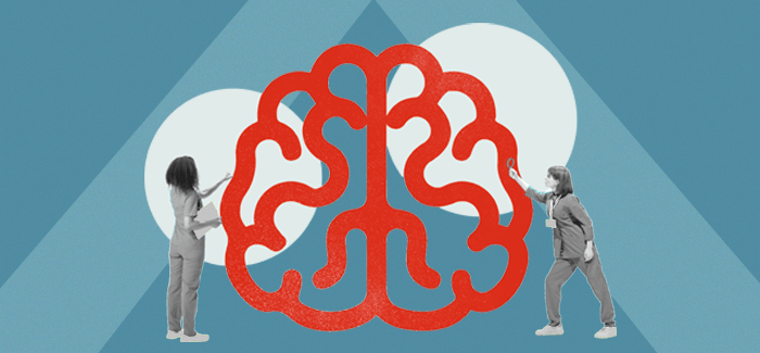 Two nurse educators looking at an oversize cartoon of a brain