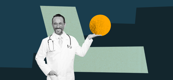 Male nurse smiling and holding an orange orb in front of a step to signify levels of nursing and degrees possible