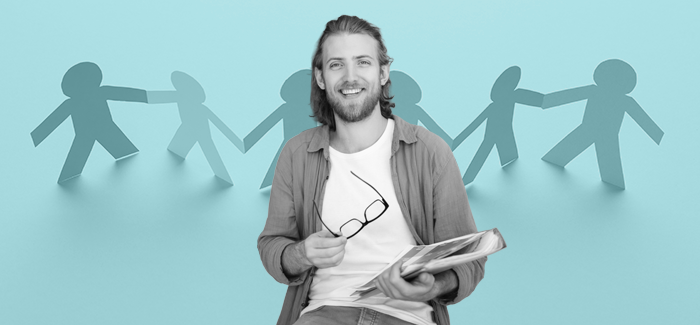 Man with a 3-ring binder holding his eyeglasses in front of a blue background with cut-out figures of people to signify how to become a social worker