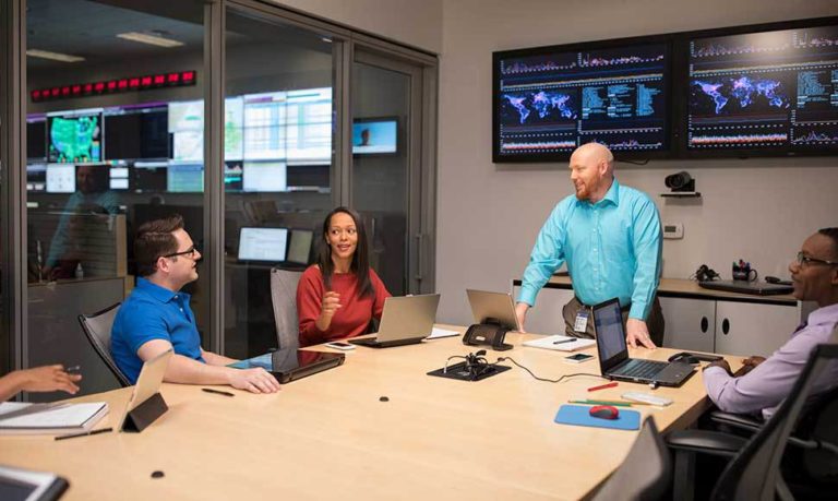 Dustin Cloos leads an IT team meeting