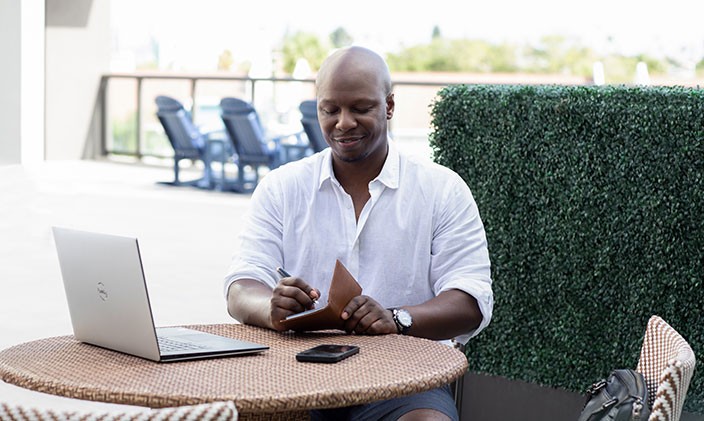 Dr. Patrick Horton sitting at a table writing in a notebook