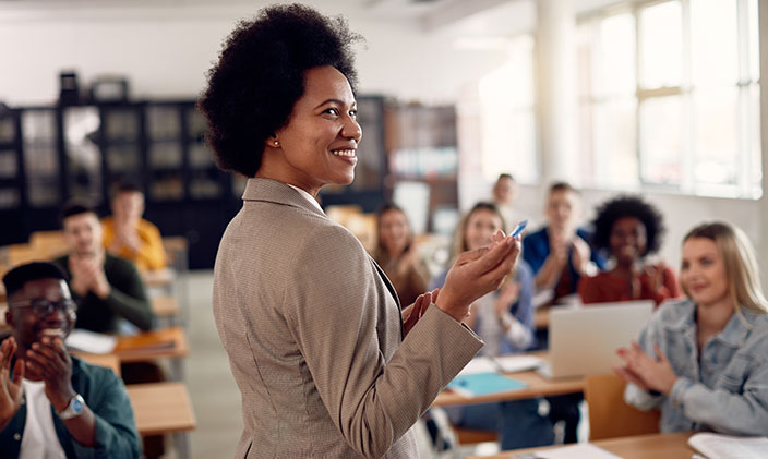 African american female college professor smiling while giving lesson
