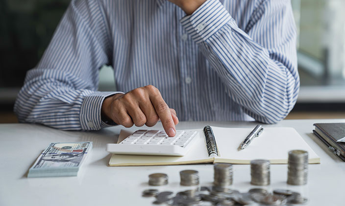 Male professional calculating salaries