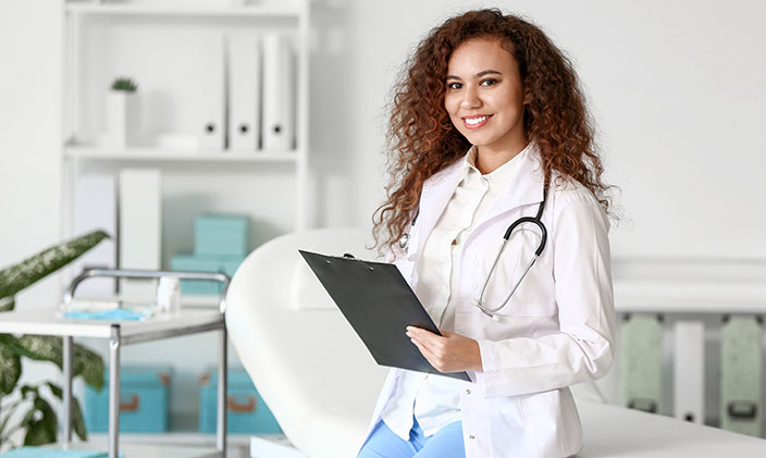 Female doctor smiling with a clipboard