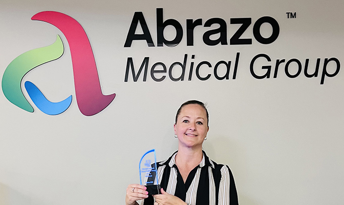 Terri Cascia holds an award at work