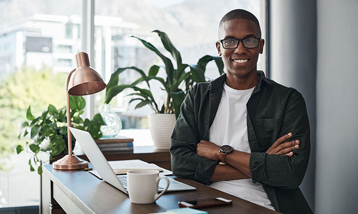Young, smiling male professional thinking about cybersecurity tips