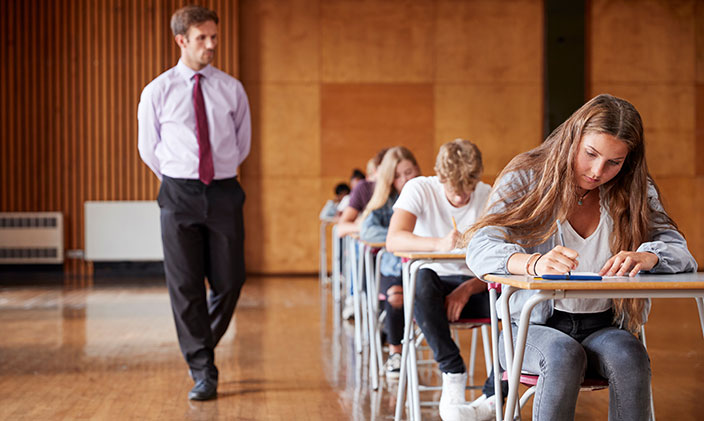 Teacher overseeing students taking exam