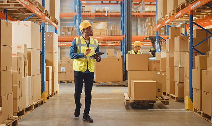 Logistics manager looking over inventory in a warehouse