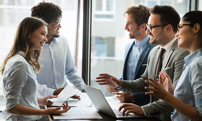 Group of business people smiling at a meeting