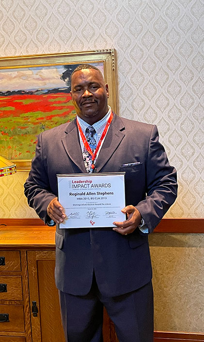 Reginald Stephens holds an award