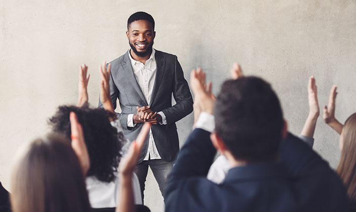 Audience clapping at business leader 