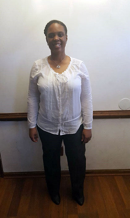 Portrait of Ivory Morris smiling in a hallway