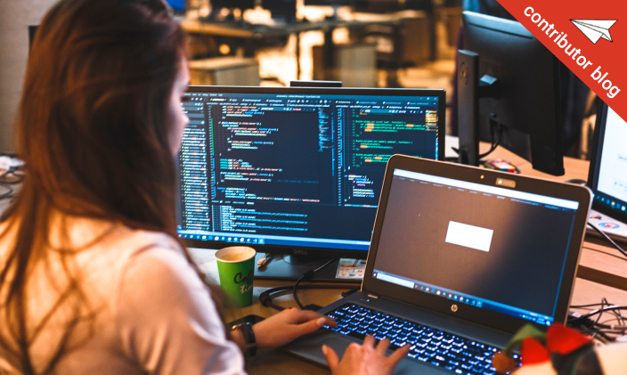 Female profressionls working at a workstation with monitors and laptop
