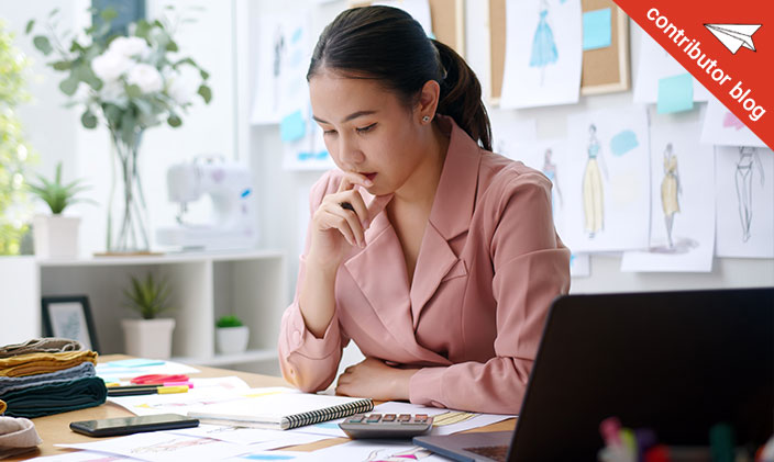 Pensive Asian woman working at a desk 