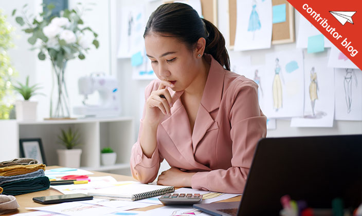 Pensive Asian woman working at a desk