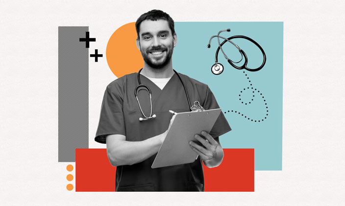 A male nurse smiling and writing a note on a clipboard