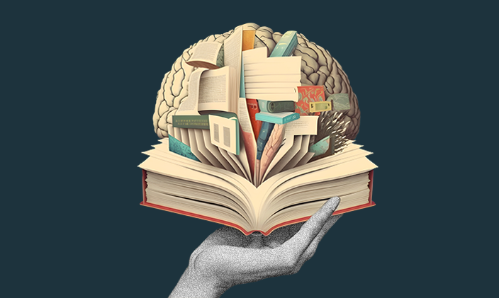 Photo of hand holding an open book with a brain coming out of it