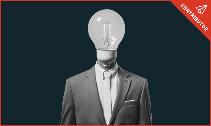 A business man's body in a suit with a lightbulb head