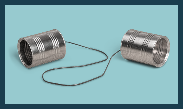 two tin cans linked by a string to fashion a childhood telephone