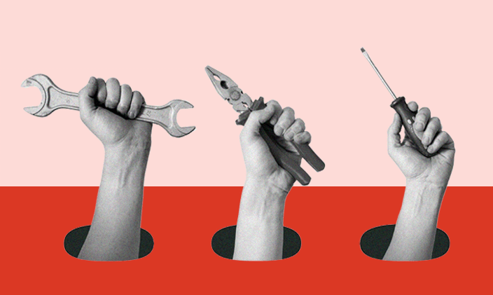 Hands holding up tools to represent technical tools and skills