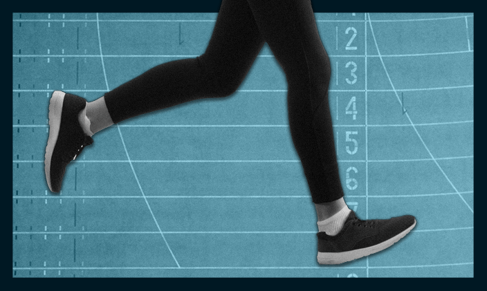 A woman's legs running toward a finish line